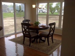 Lovely breakfast nook with wooden table and chairs in Rochester home