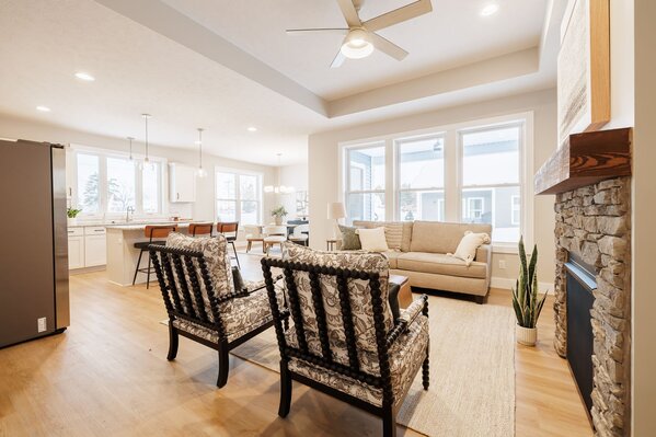 02-fourmile-creek-open-concept-living-stone-fireplace-tray-ceiling-1