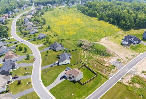 Aerial view of suburban neighborhood and open land in Greater Rochester, NY