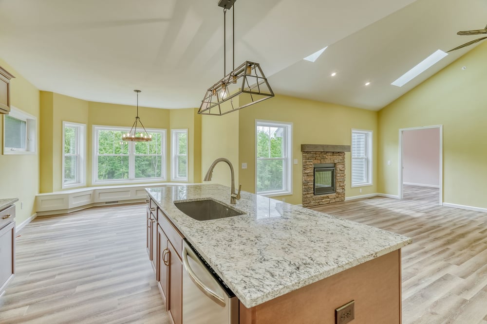 Custom home first floor open-concept layout with kitchen island by Gerber Homes
