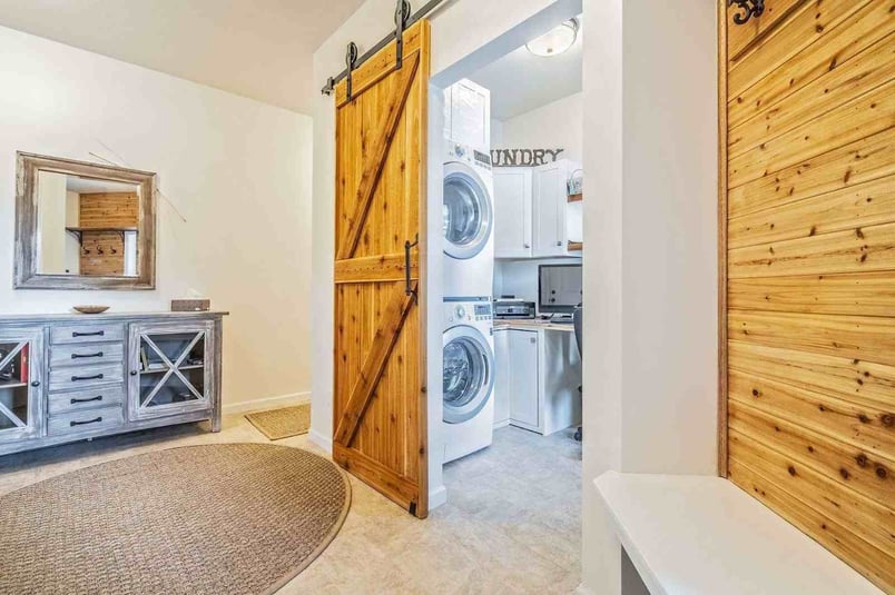 Custom laundry room, Custom Mudroom, Custom sliding wood barn doors, wood accents, custom bench with wooden back, tiled flooring by Gerber Homes Whiting Rd_11zon