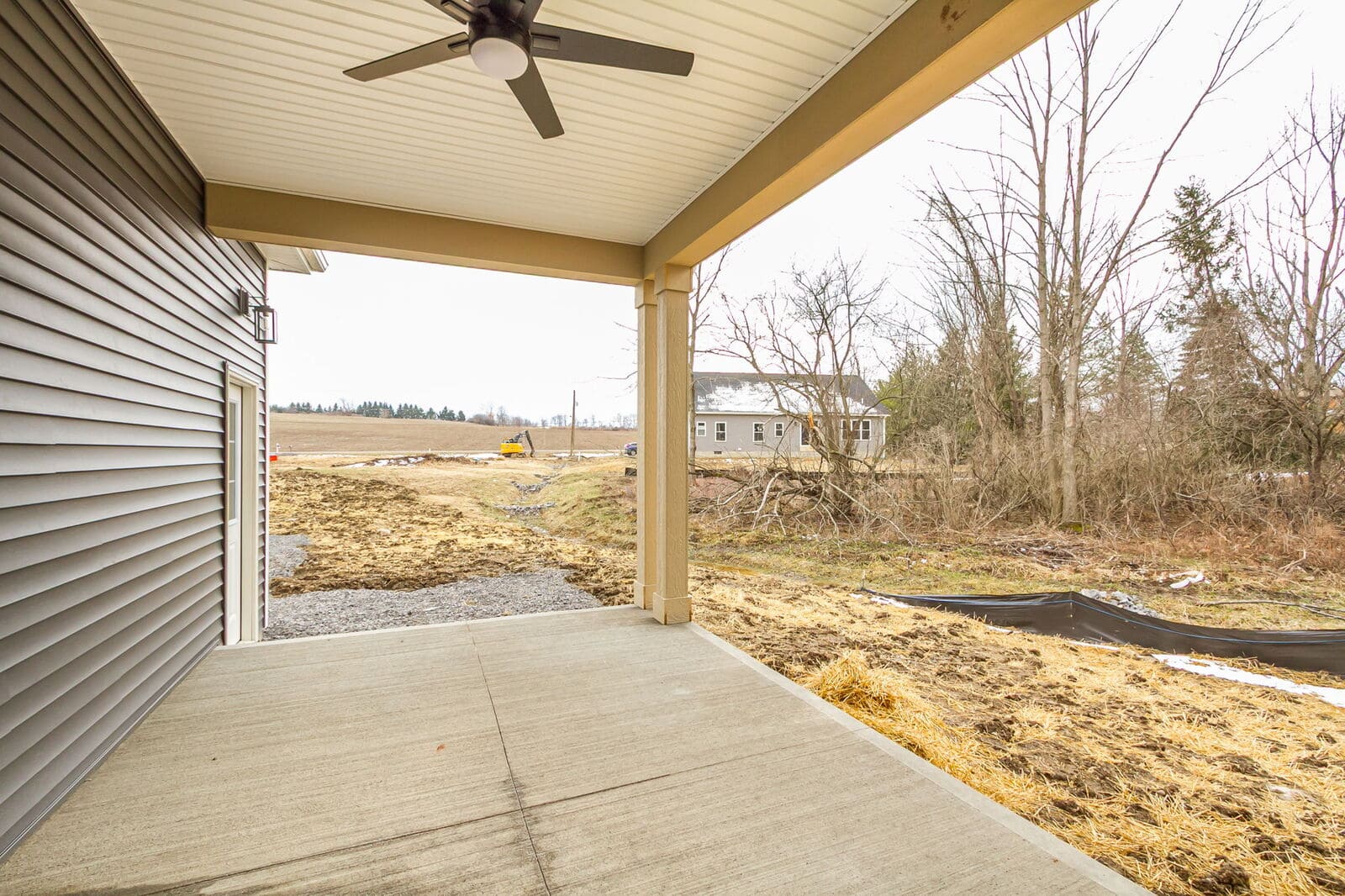 Covered patio overlooking the backyard and neighboring homes in Canandaigua.