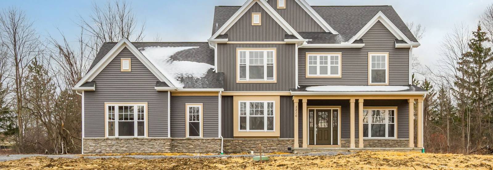 Front exterior of new construction home in Canandaigua, NY under blue sky
