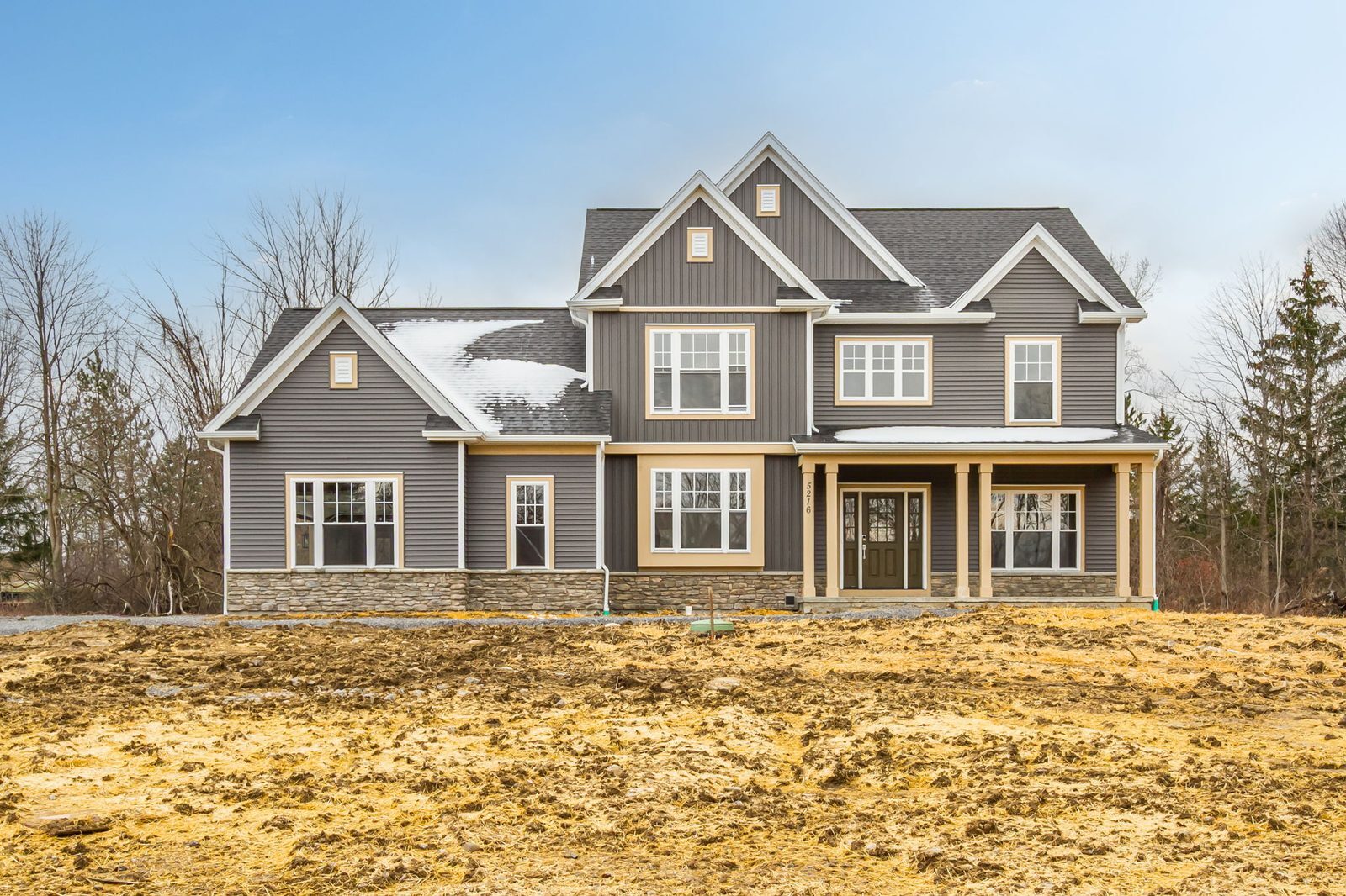Front exterior of new construction home in Canandaigua, NY under blue sky
