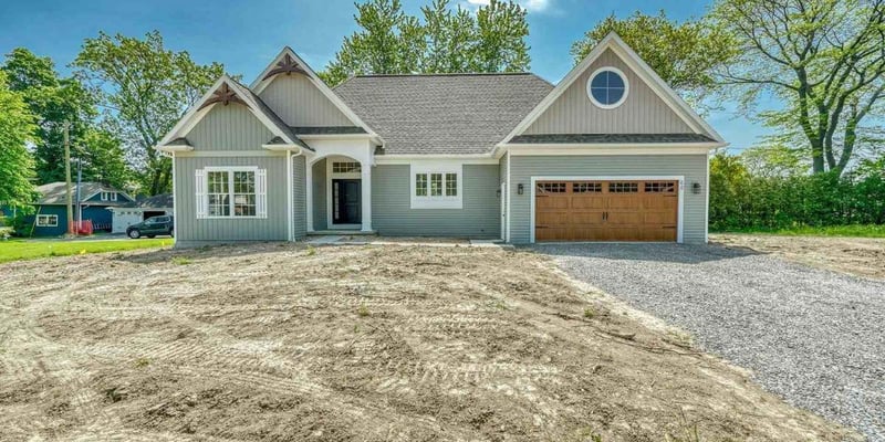 Front exterior of custom ranch home with attached garage near Rochester