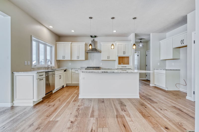 Luxury kitchen in upstate Rochester, NY custom home with island and white cabinets