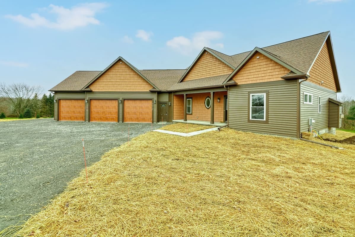 One-story ranch custom home exterior with attached three-car garage by Gerber Homes