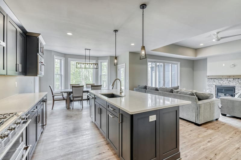 Open-concept interior of kitchen and great room with coffered ceiling by Gerber Homes