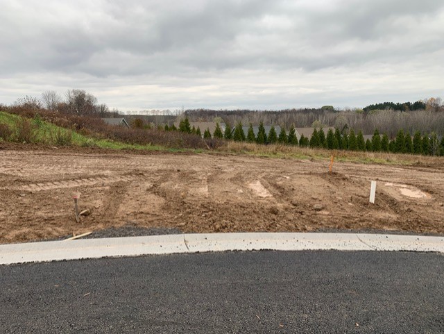 Paved road and land development progress in new home community in Walworth, NY by Gerber Homes