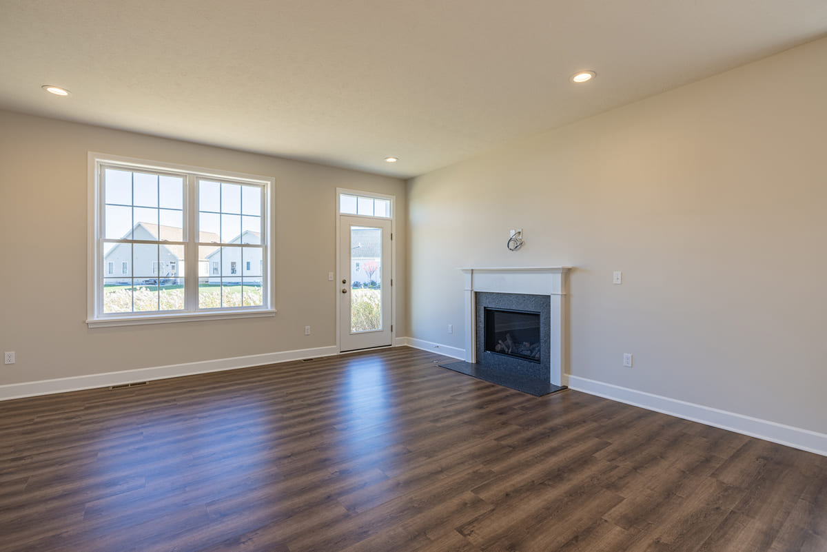 Fireplace on first floor near door in The Cottages of Canandaigua