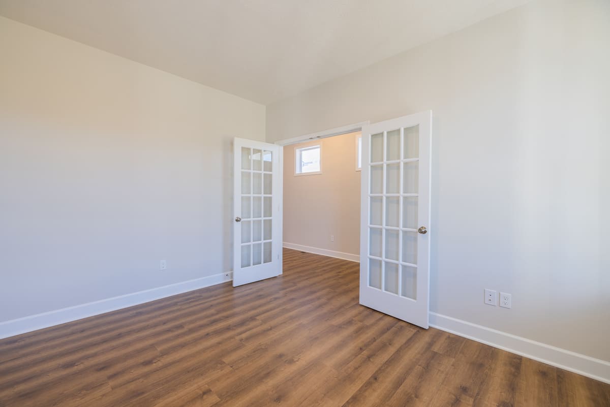 Two white French doors opening to room in The Cottages of Canandaigua new home development