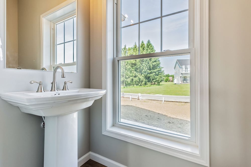 Sink near window in bathroom of Rochester custom home by Gerber Homes