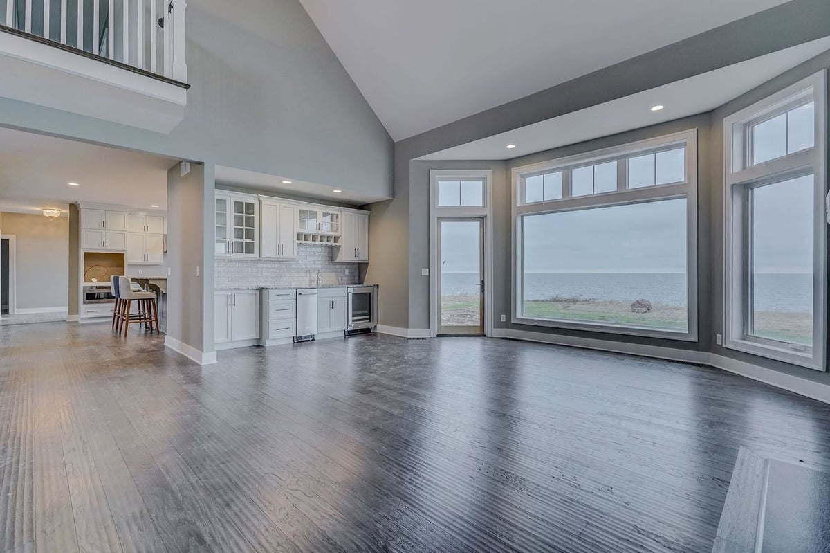 Lakefront custom home main floor open-concept interior with lakefront view by Gerber Homes