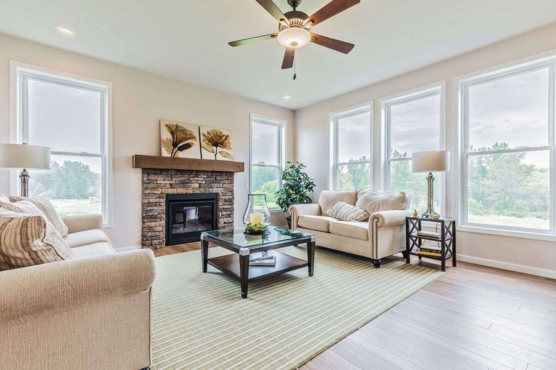 Living room in greater Rochester custom home with stone fireplace by Gerber Homes