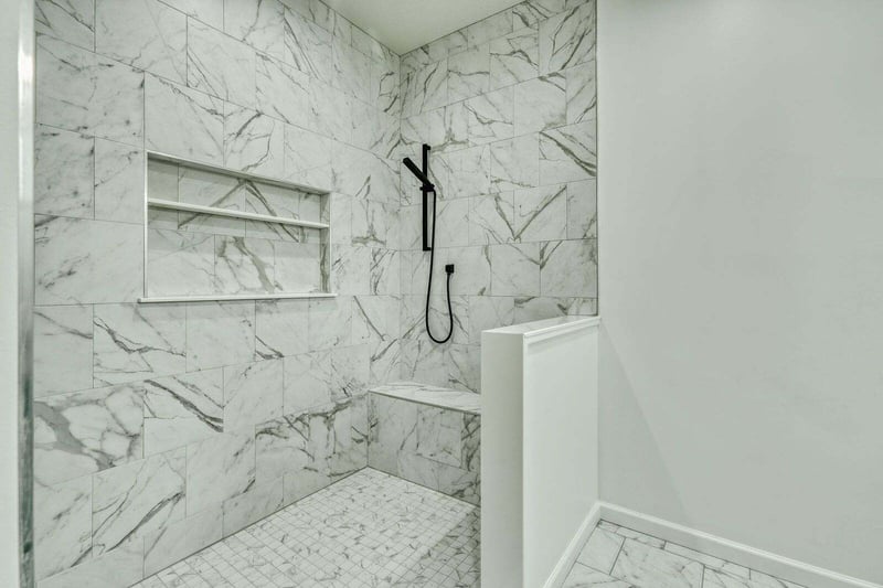 Modern barrier-free walk-in shower with built-in bench and shelf