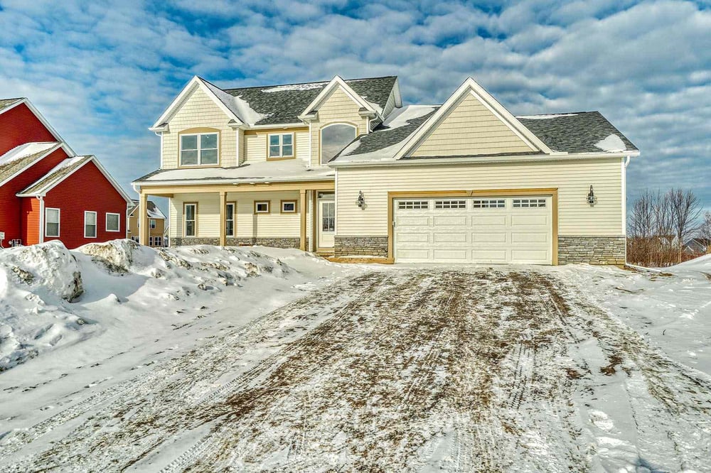 Two-story custom home exterior in snow by Gerber Homes