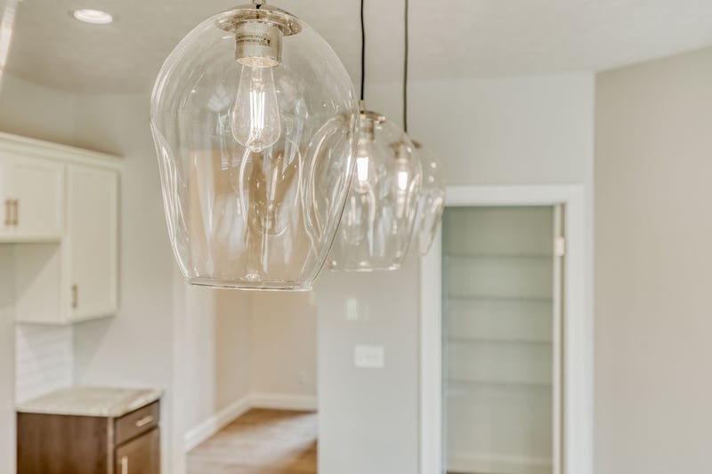Up-close view of glass bulb pendant lighting in Rochester-area custom home
