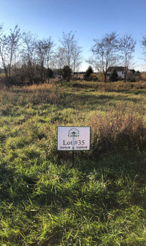 Vacant grassy lot with Lot 35 sign in Greater Rochester, NY residential development