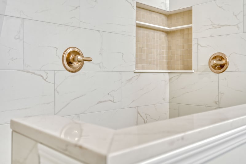 View of tiling detail in luxury bathroom in greater Rochester custom home