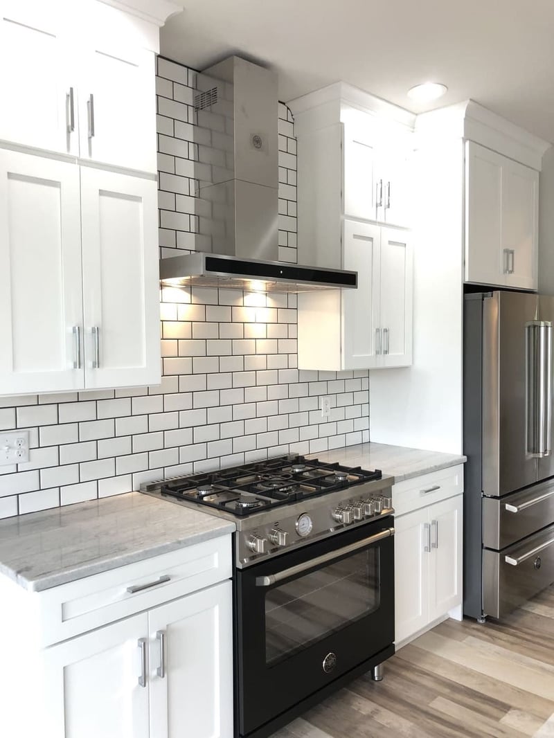 White inset kitchen cabinets in Rochester-area custom home with subway tile backsplash