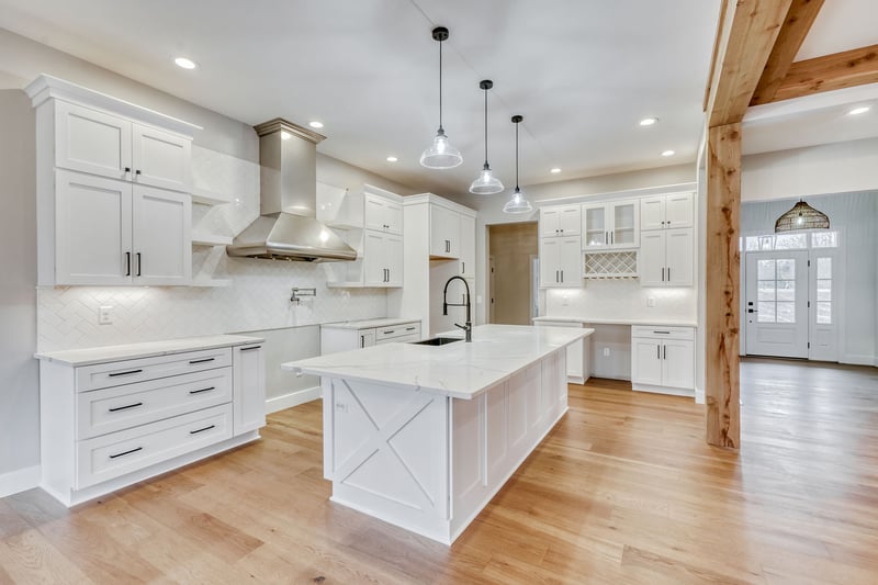 White luxury kitchen with task lighting and island in greater Rochester, NY custom home