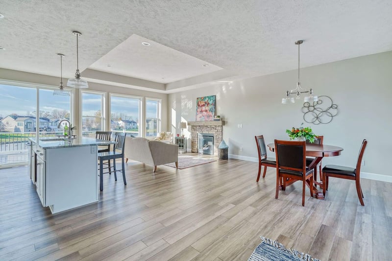 Custom home open-concept kitchen & living room with tray ceiling by Gerber Homes in Rochester, NY