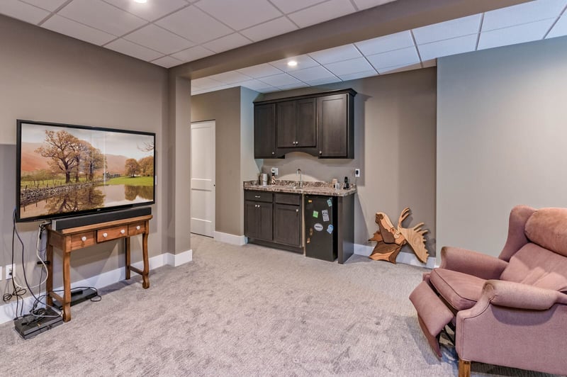 Finished basement with custom bar area with sink