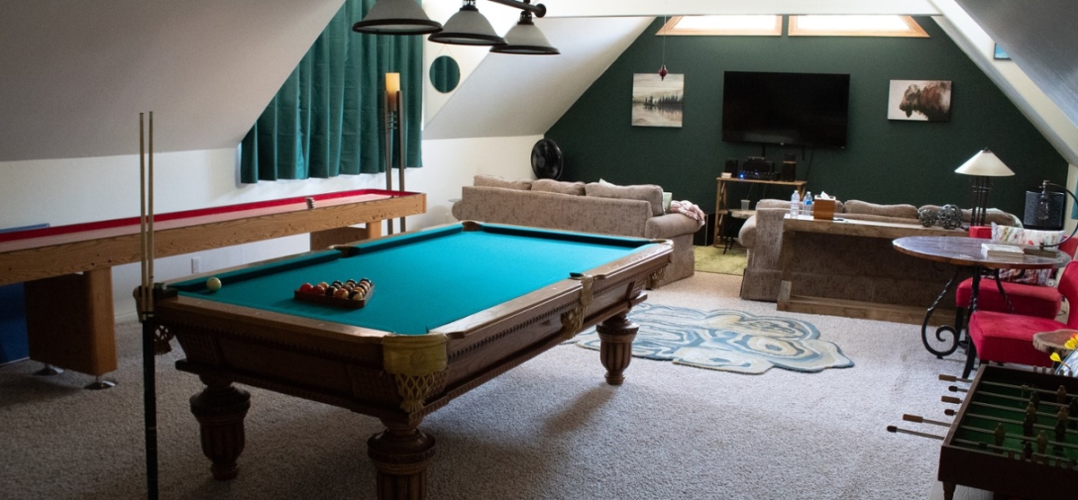 game room with pool table foosball and couches with tv-1-1