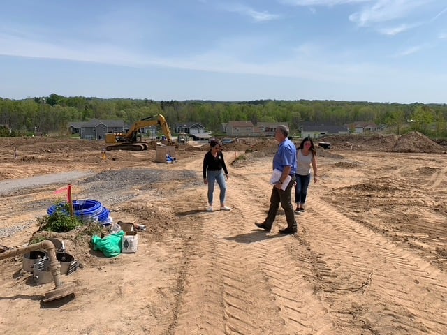 Gerber Homes team walking on lot for new construction home in Orchard View Estates