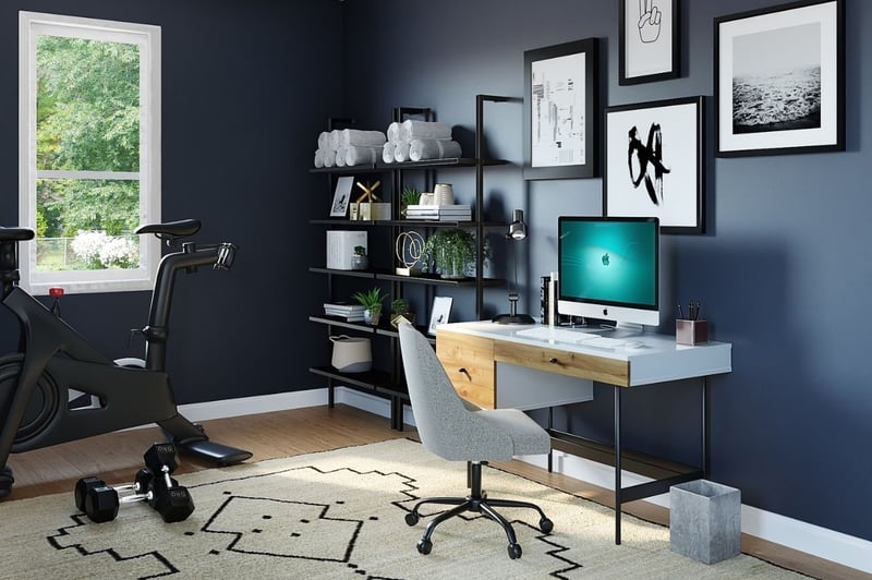 home office with desk laptop and peleton bike in Rochester, NY home