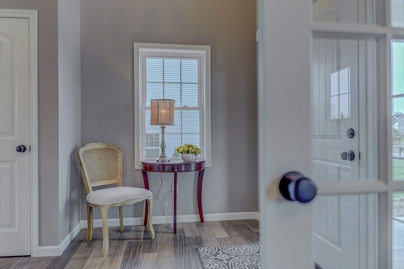 Interior entrance to custom home with small table and chair