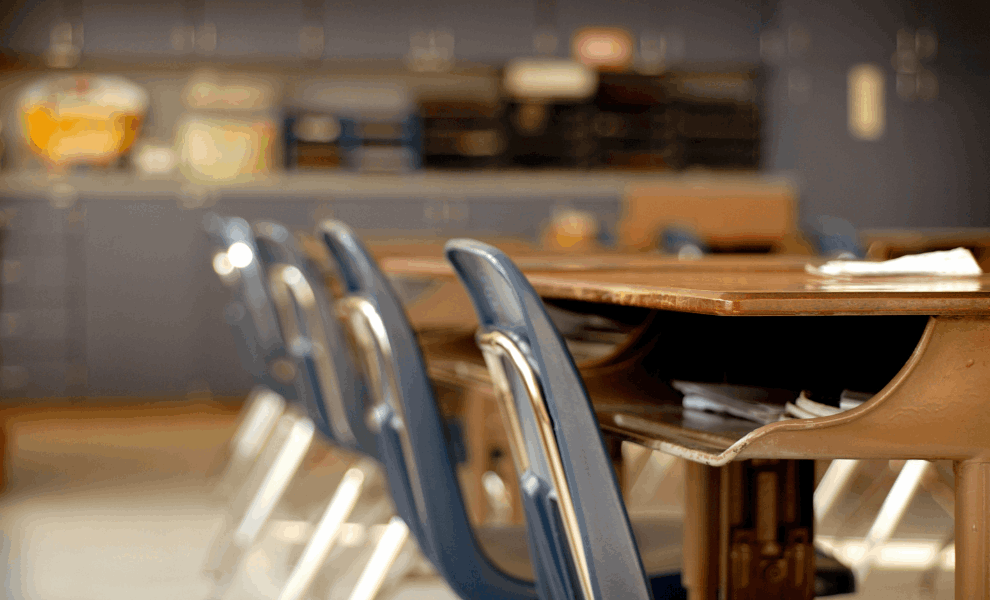 Up-close view of classroom rows of chairs and desks