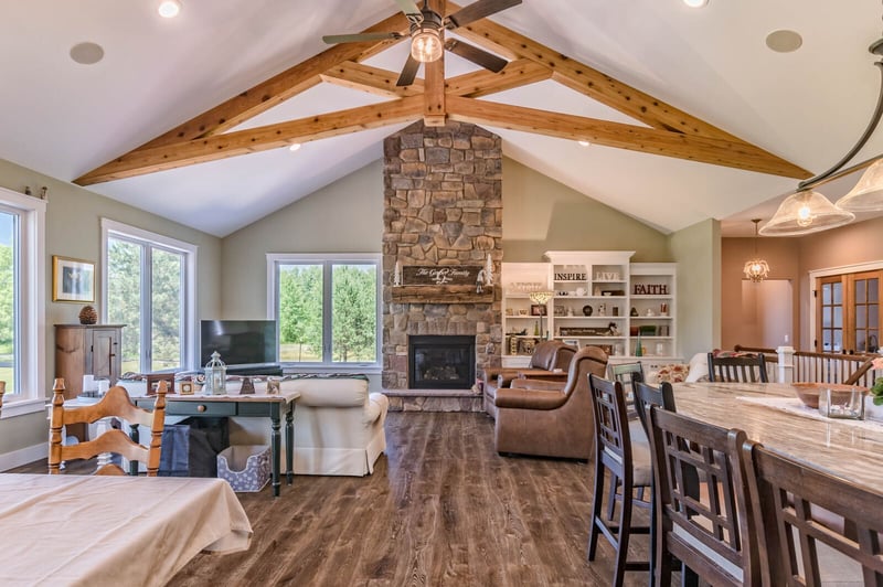 Wood flooring in open concept family room with vaulted ceiling