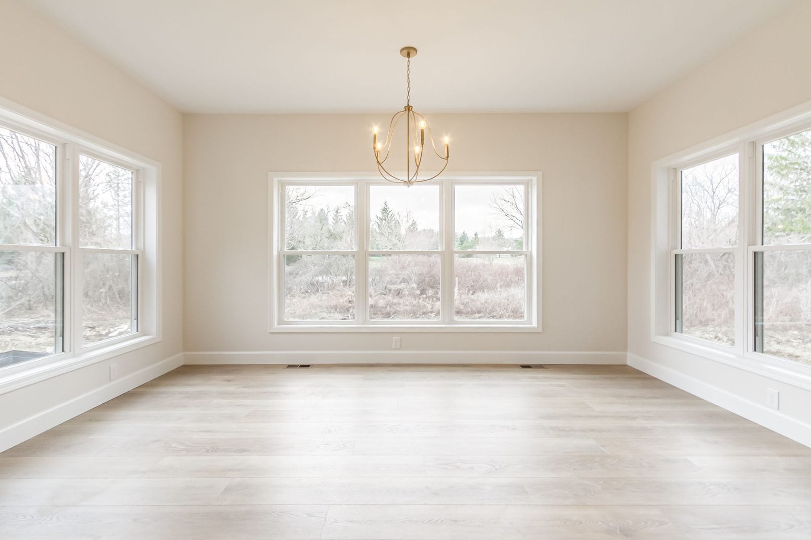 Breakfast nook with wraparound windows and chandelier