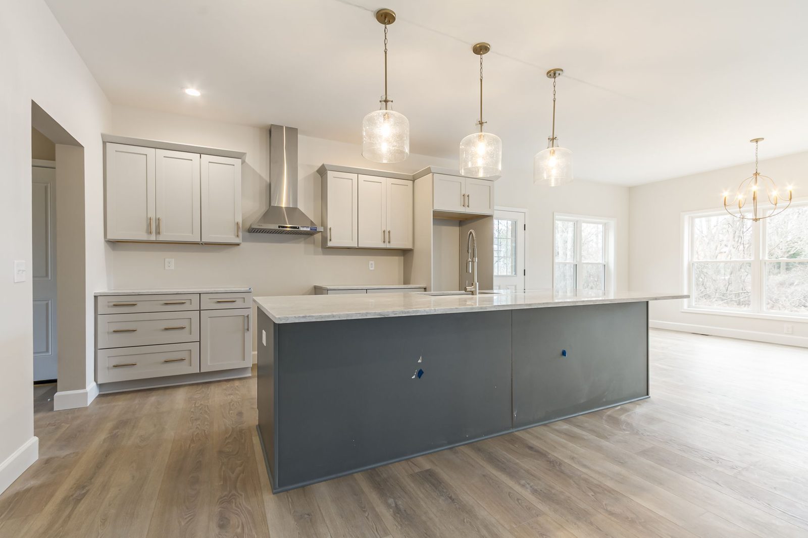 Kitchen with gray cabinetry, charcoal island, and dining nook