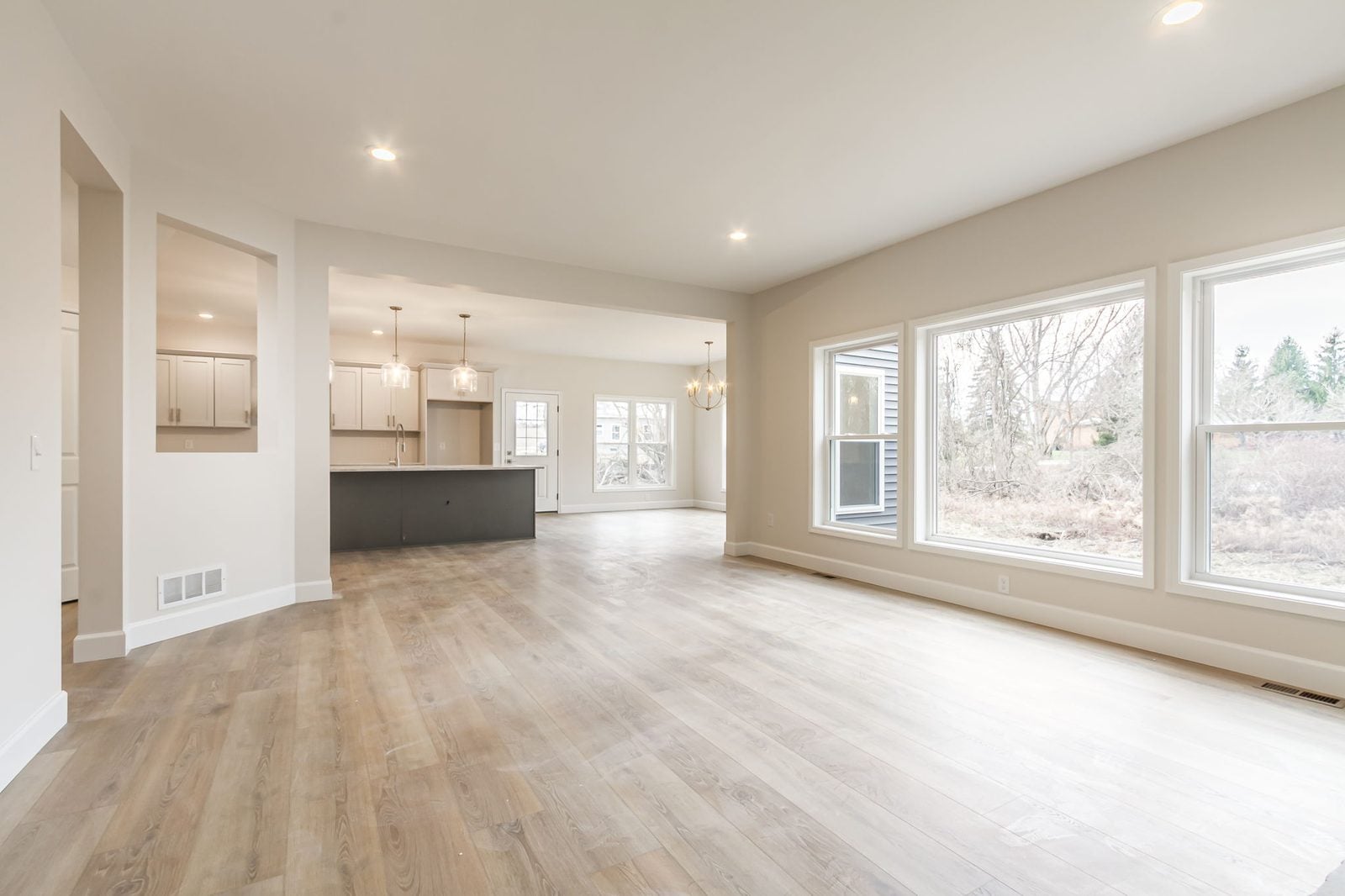 Open kitchen, living room, and dining area in a custom Canandaigua home